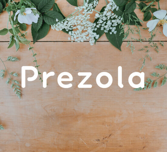 Prezola wedding logo on a wooden board with flowers