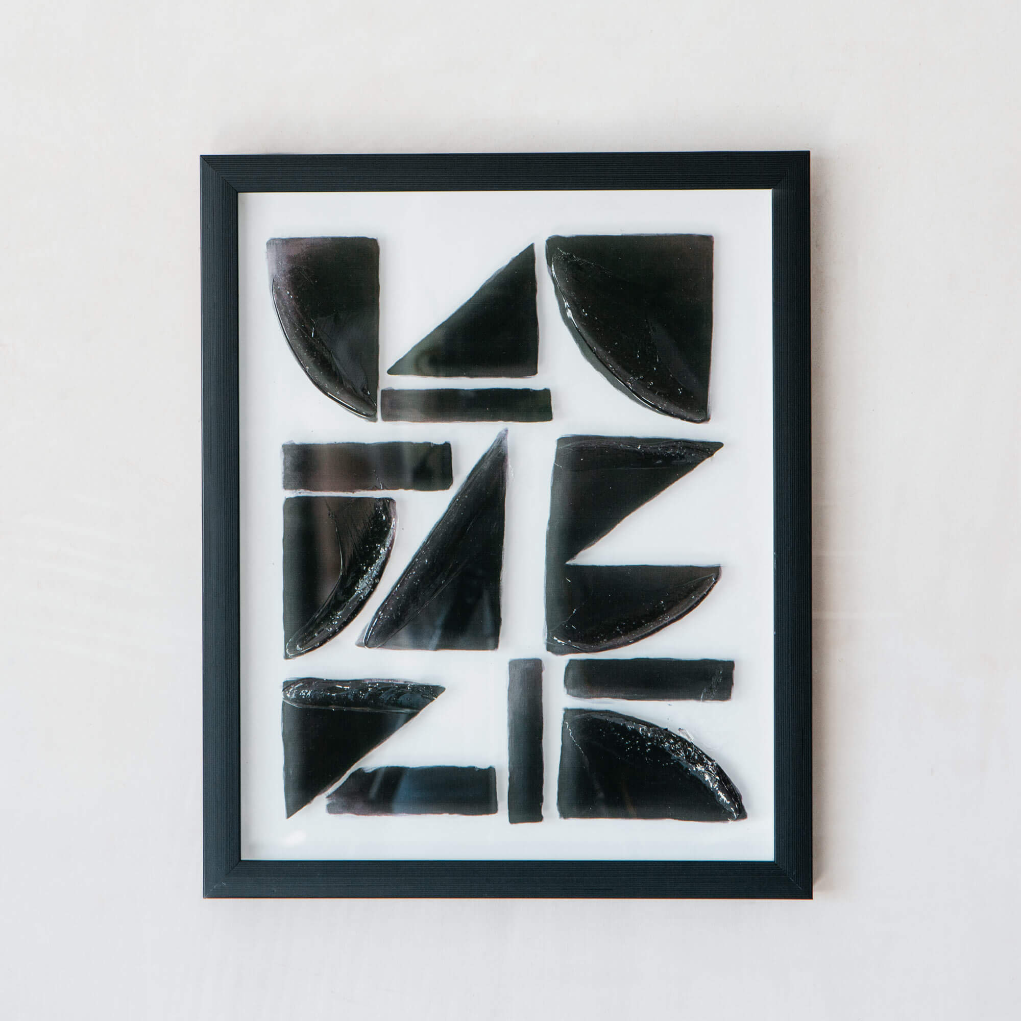 Photo of Graham and green framed black abstract shapes print